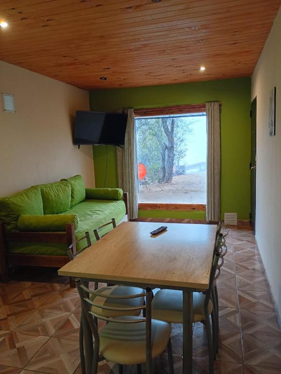 a living room with a table and a couch at Corazón Contento in Villa Pehuenia