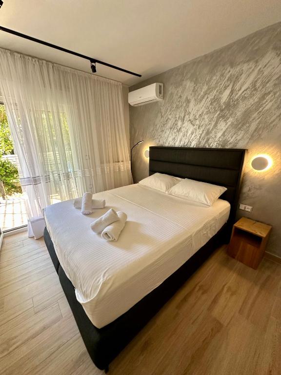 a bedroom with a bed with two towels on it at SMART COASTAL RETREAT Apartment in Alexandroupoli