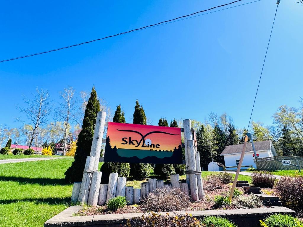 a sign for a skyline sign in a yard at Skyline Cabins in Ingonish