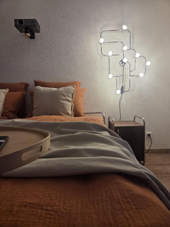 a bedroom with a bed and a chandelier at Calm Sun Apartment in Alpirsbach