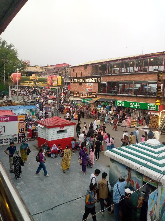 a large crowd of people walking around a market at Hotel Marhaba in in Murree