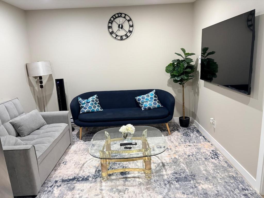 a living room with a couch and a glass table at Olas Place in Regina