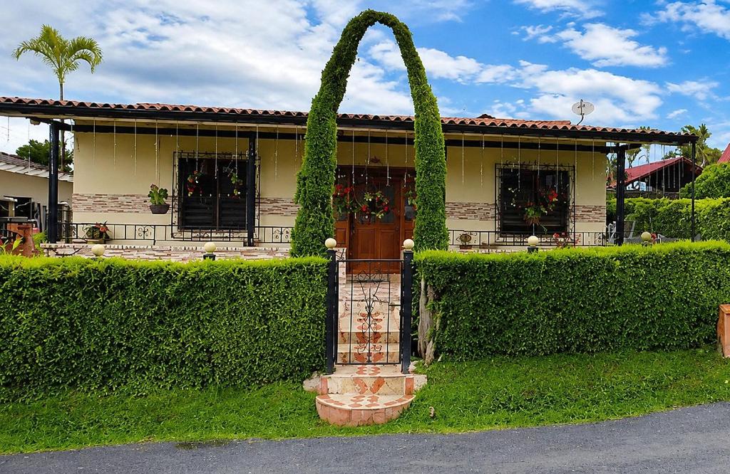 a house with a gate in front of it at Casa campestre cerca de termales con WiFi y parqueadero in Santa Rosa de Cabal
