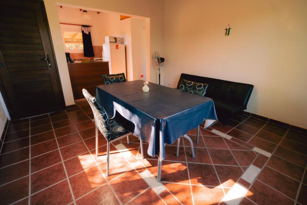 a dining room table with chairs and a blue table cloth at Cabañas Entre Campos in Los Reartes