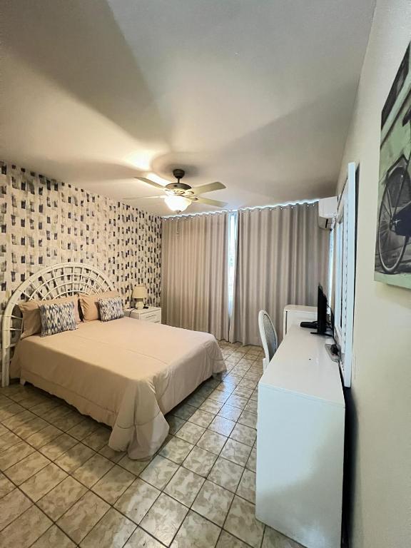 a bedroom with a bed and a flat screen tv at Modern Santo Domingo Condo in Heart of Gazcue in Santo Domingo