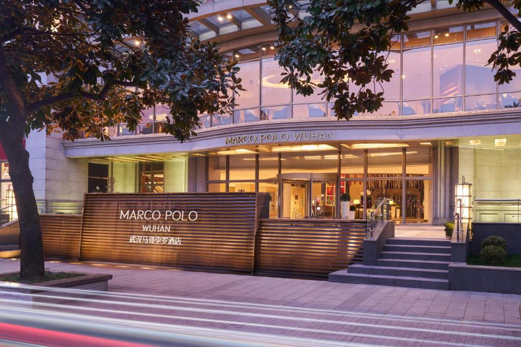 a store front of a building with stairs in front at Marco Polo Wuhan in Wuhan