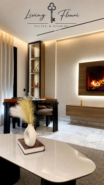 a living room with a table and a fireplace at Living Fleuri Suites & Studios in Casablanca