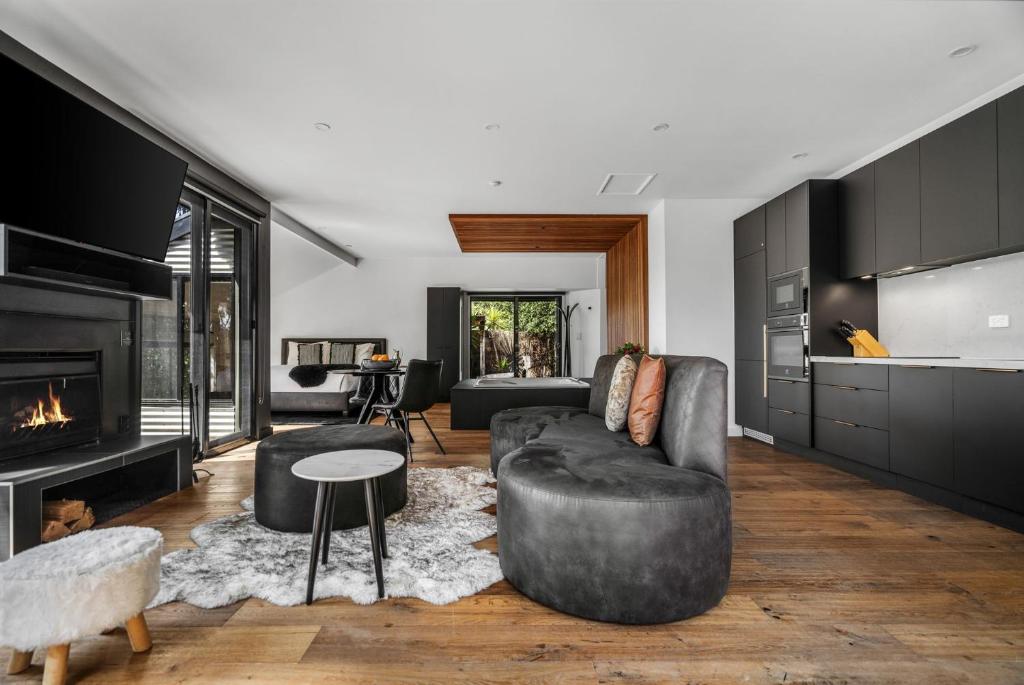 a living room with a couch and a fireplace at Istana Indulge in Hepburn Springs