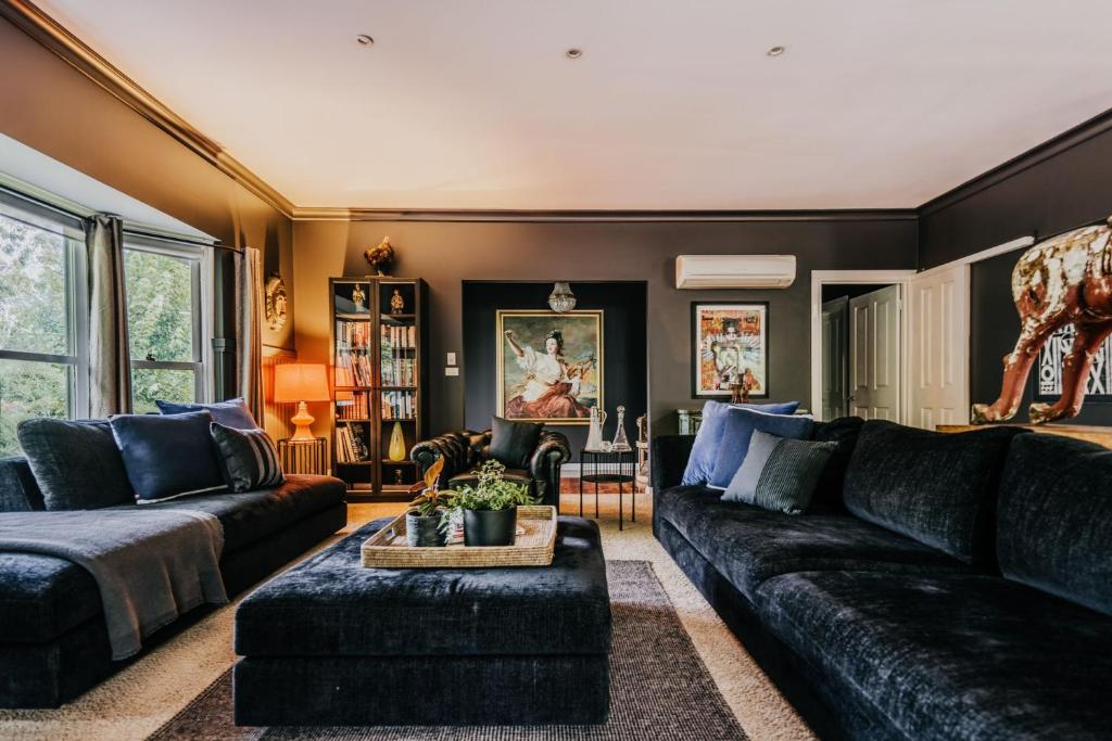 a living room with a couch and a table at Istana Lodge in Musk Vale