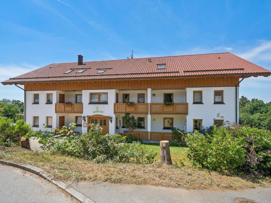 a large white house with a red roof at Max in Waldkirchen
