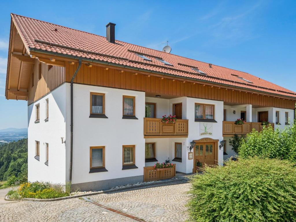 a large white house with a red roof at Hans in Waldkirchen