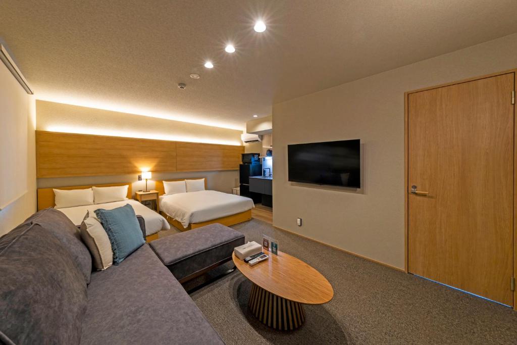 a living room with a couch and a bed at GRAND BASE Peace Park in Nagasaki