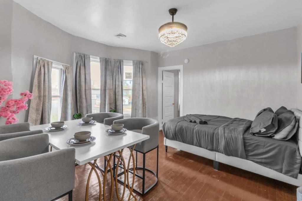 a bedroom with a bed and a table and chairs at 4BR Apt Pool Table Sleeps 9 Buffalo in Buffalo