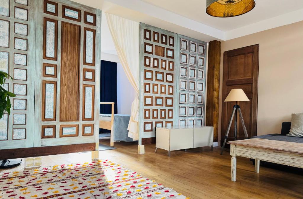 a living room with a bed and a rug on the floor at El cuarto AZUL in Urrugne