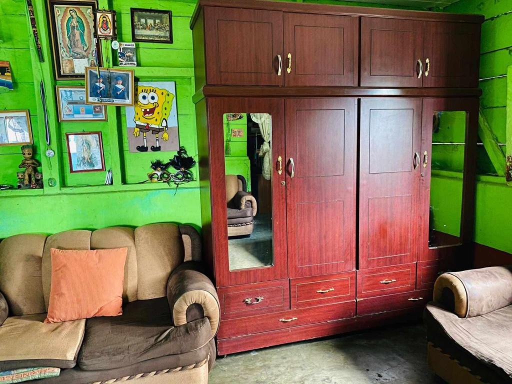 a living room with a large cabinet and a couch at Casa cerca de IRTRA in San Martín Zapotitlán