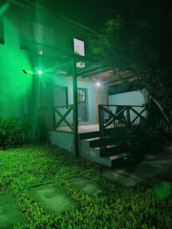 a house at night with a green light at Sítio Casa Verde in Uruguaiana