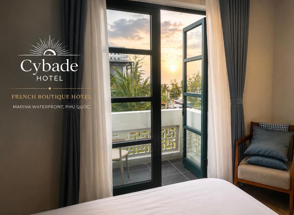 a hotel room with a bed and a window at Cybade Hôtel in Phú Quốc
