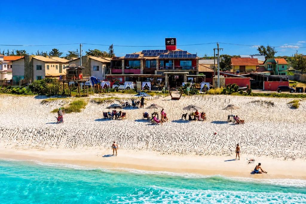 a group of people on a beach near the water at Pier Beach Club in Cabo Frio