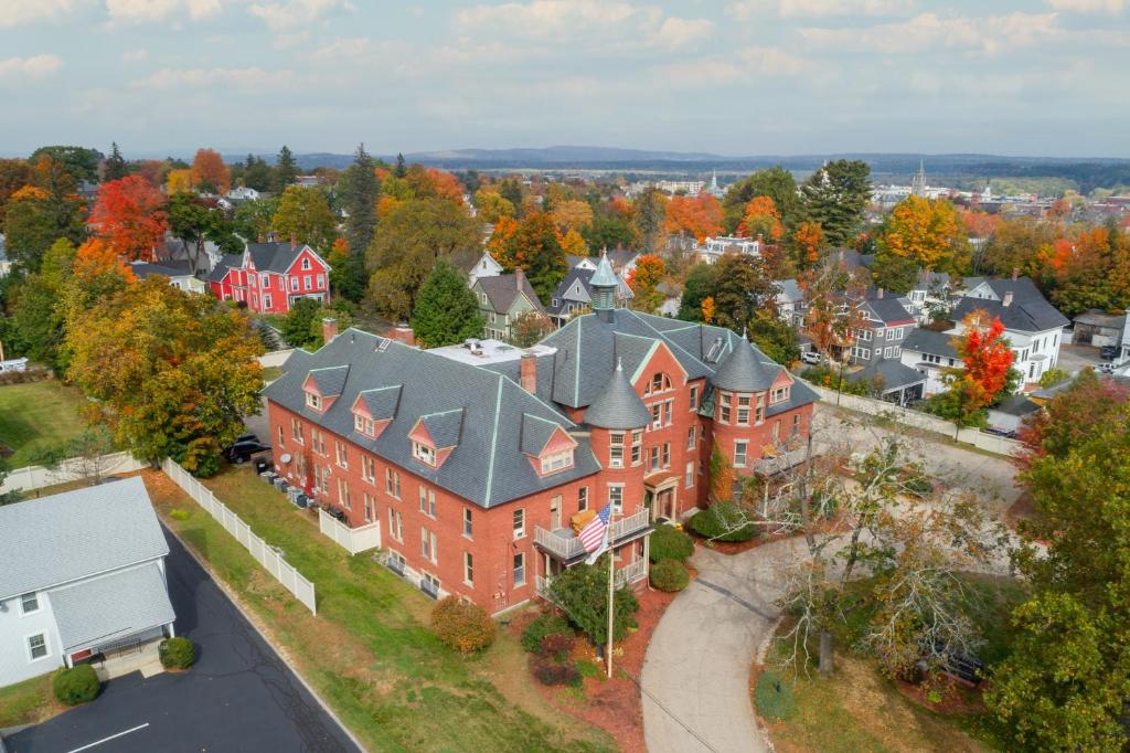 an aerial view of a large red brick house at The Centennial Hotel in Concord