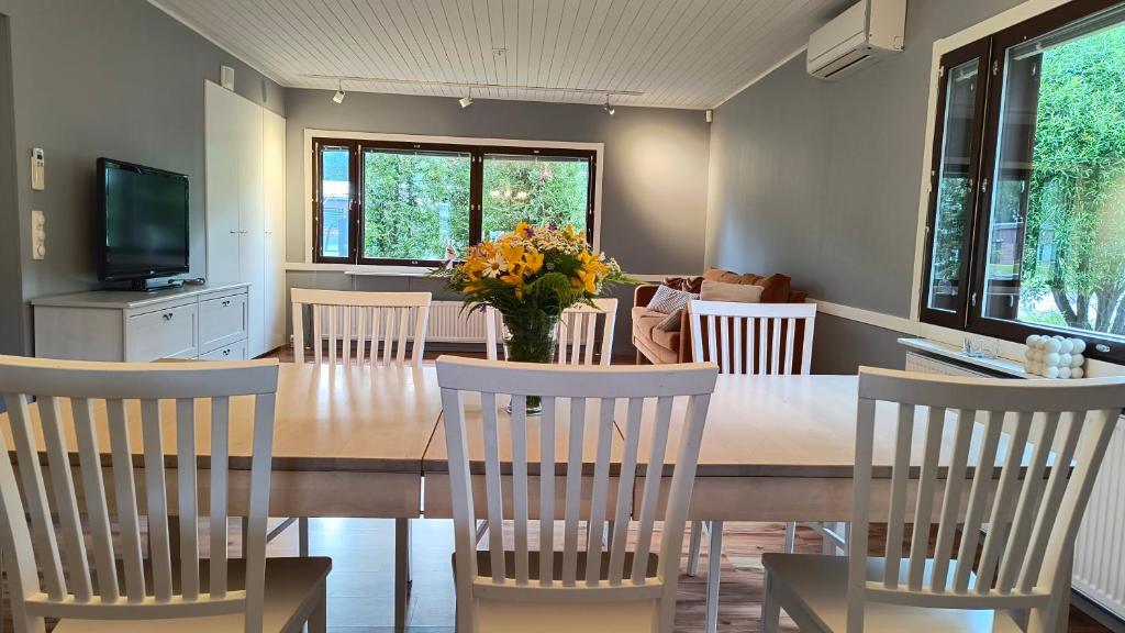 a dining room with a wooden table and chairs at Ventum Village in Punkaharju