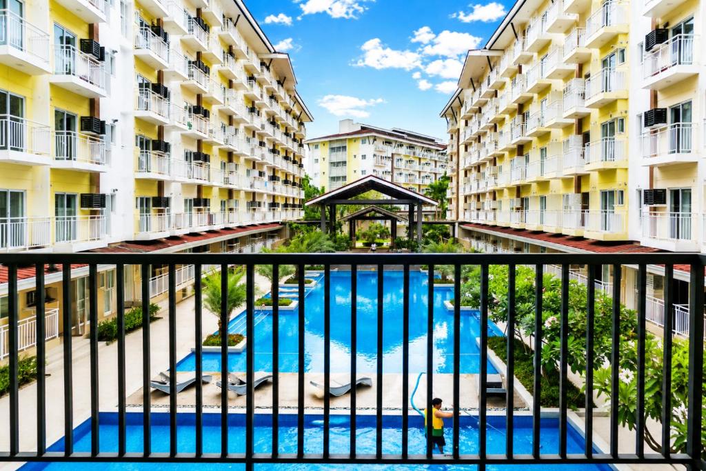 a view from the balcony of a apartment building with a swimming pool at 2 Mins Away from Mactan Cebu Airport in Pusok