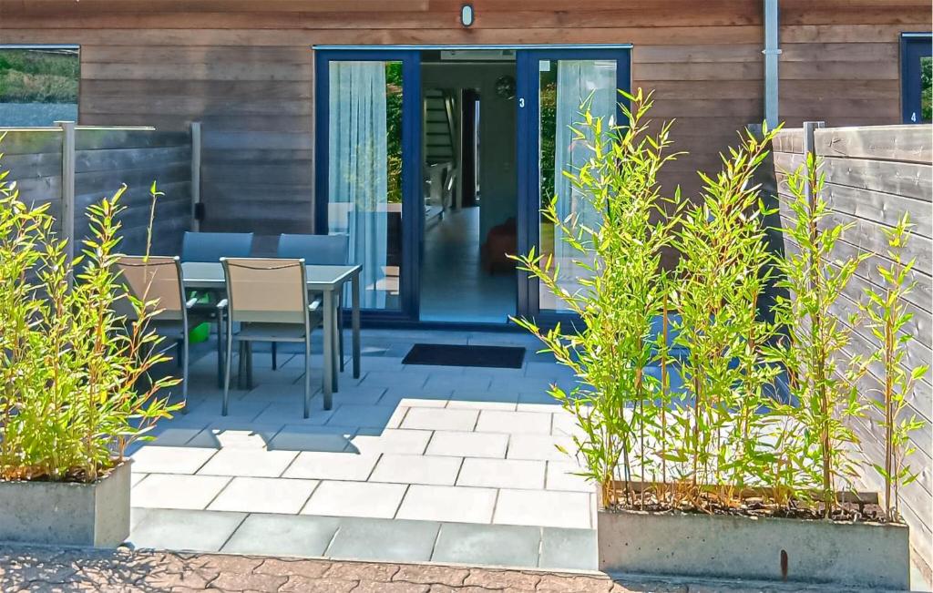 a patio with a table and chairs in front of a house at Golf 3 in Middelkerke