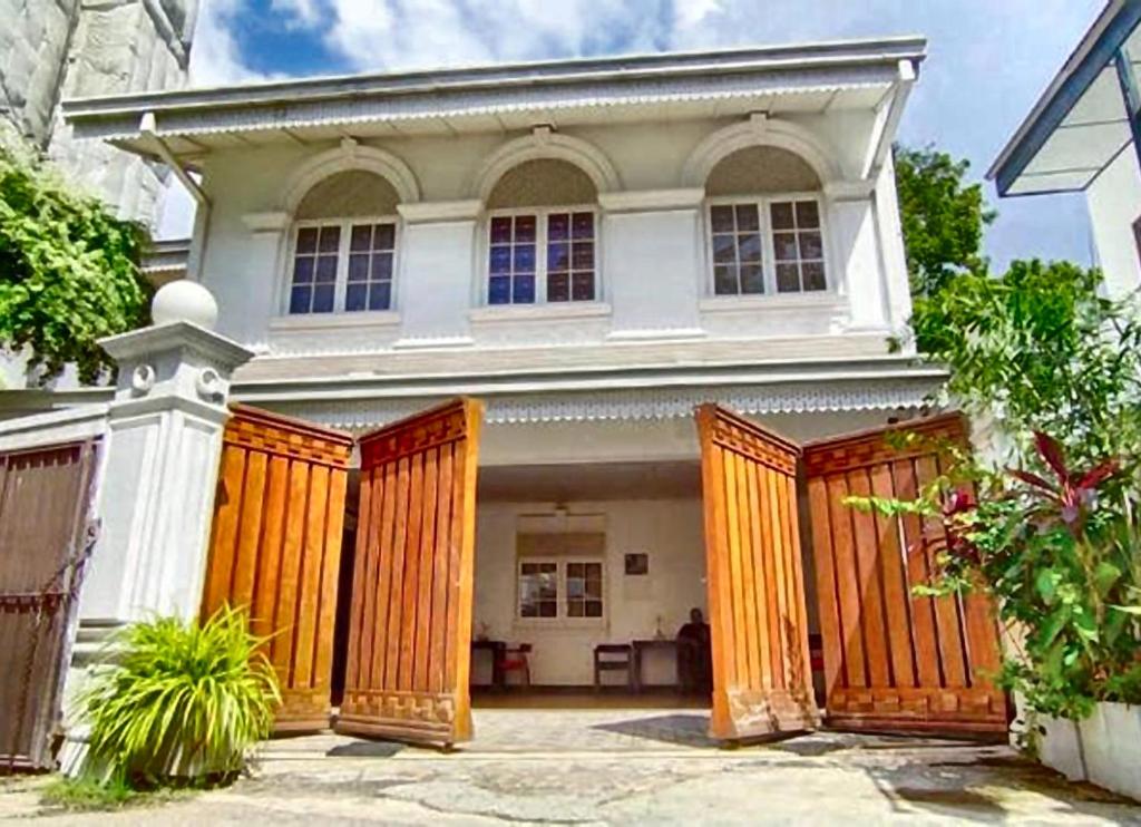 a house with wooden gates in front of it at Tarshish Villa - Colombo in Colombo