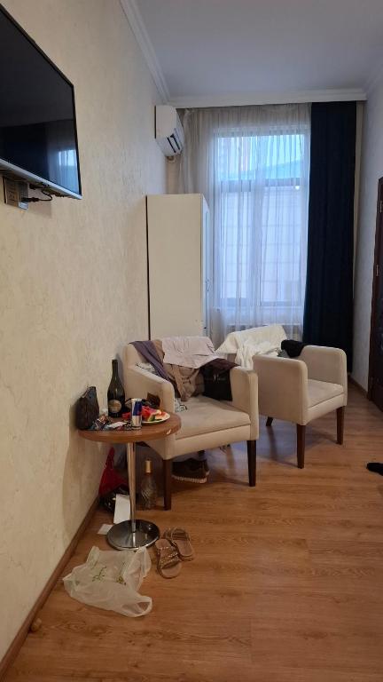 a living room with a couch and a table at The Golden Street Hotel in Baku