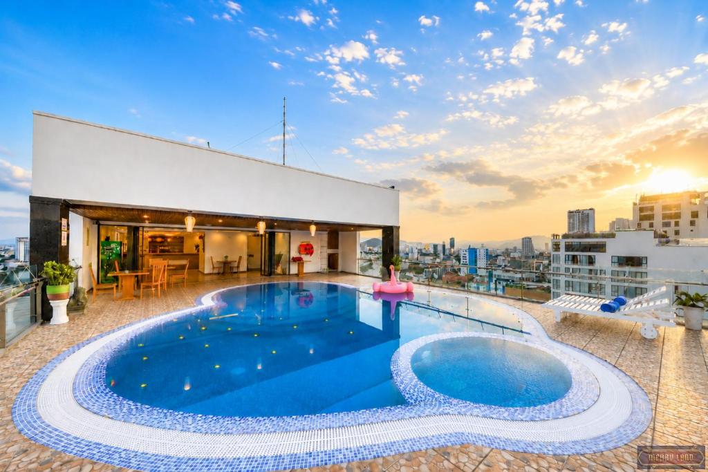 a swimming pool on the roof of a building at Merry Land Hotel Da Nang in Danang