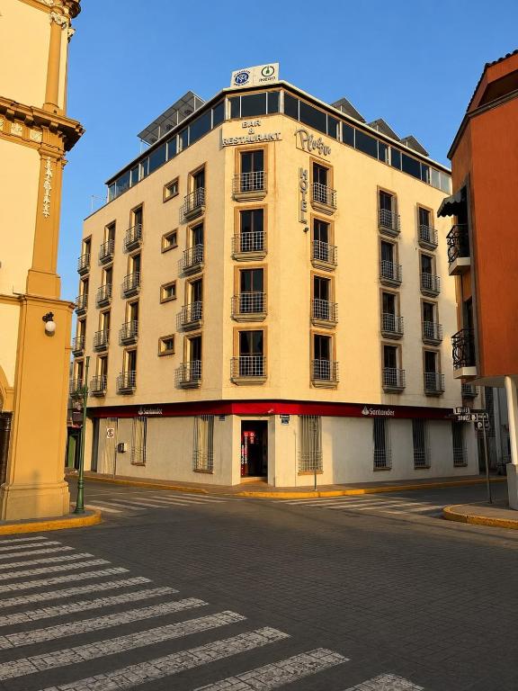 a large building on the corner of a street at Hotel Plaza in Tepatitlán de Morelos