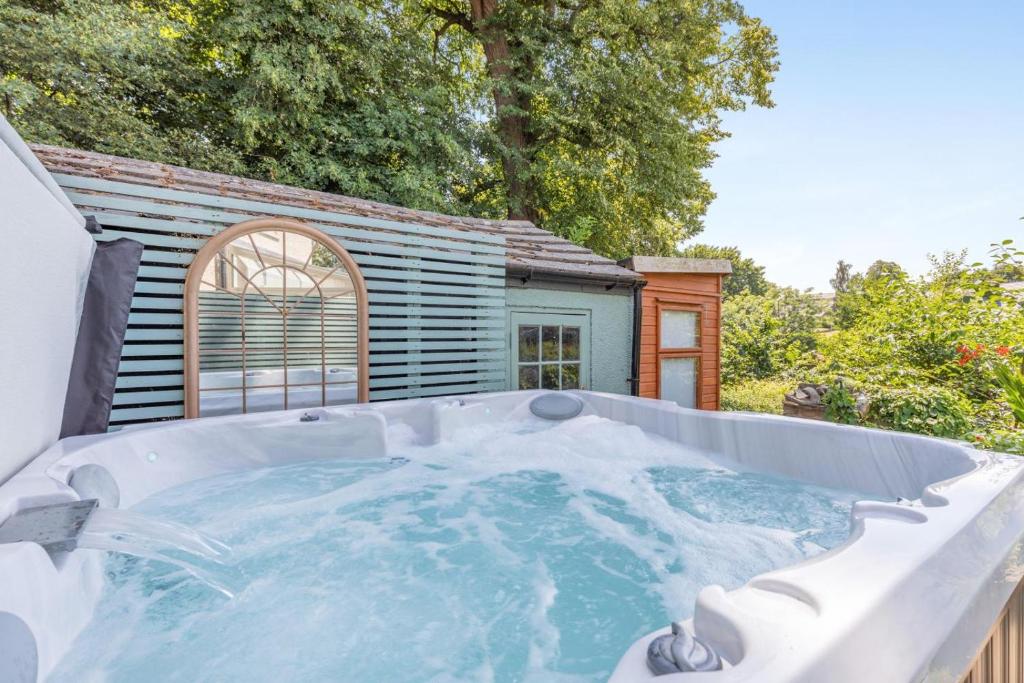 a hot tub in front of a house at 3 Bed in Bakewell oc-96293 in Baslow