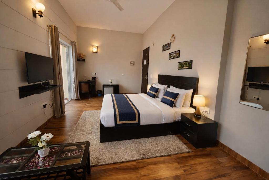 a hotel room with a bed and a television at The Amber Signature Vrindavan # A Luxury Apartment With #Lift# Garden # Parking# Ac Rooms# & Elegant interior # Located Inside- Omaxe Eternity Vrindavan in Vrindāvan
