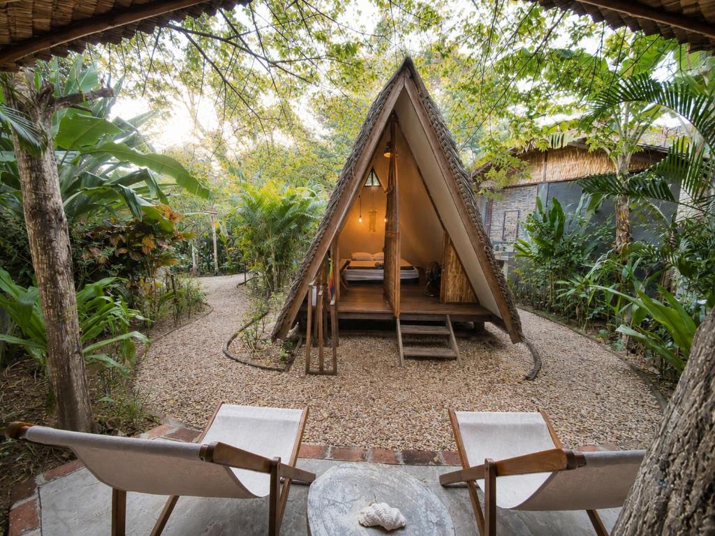 a small tent in the middle of a garden at Basabasi Island Lodge in Karimunjawa