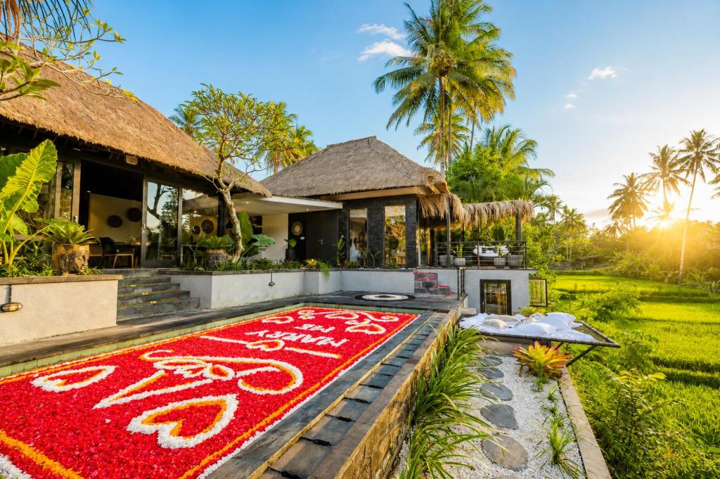 a large red rug in front of a house at Villa Jasmine by Anakara in Ubud