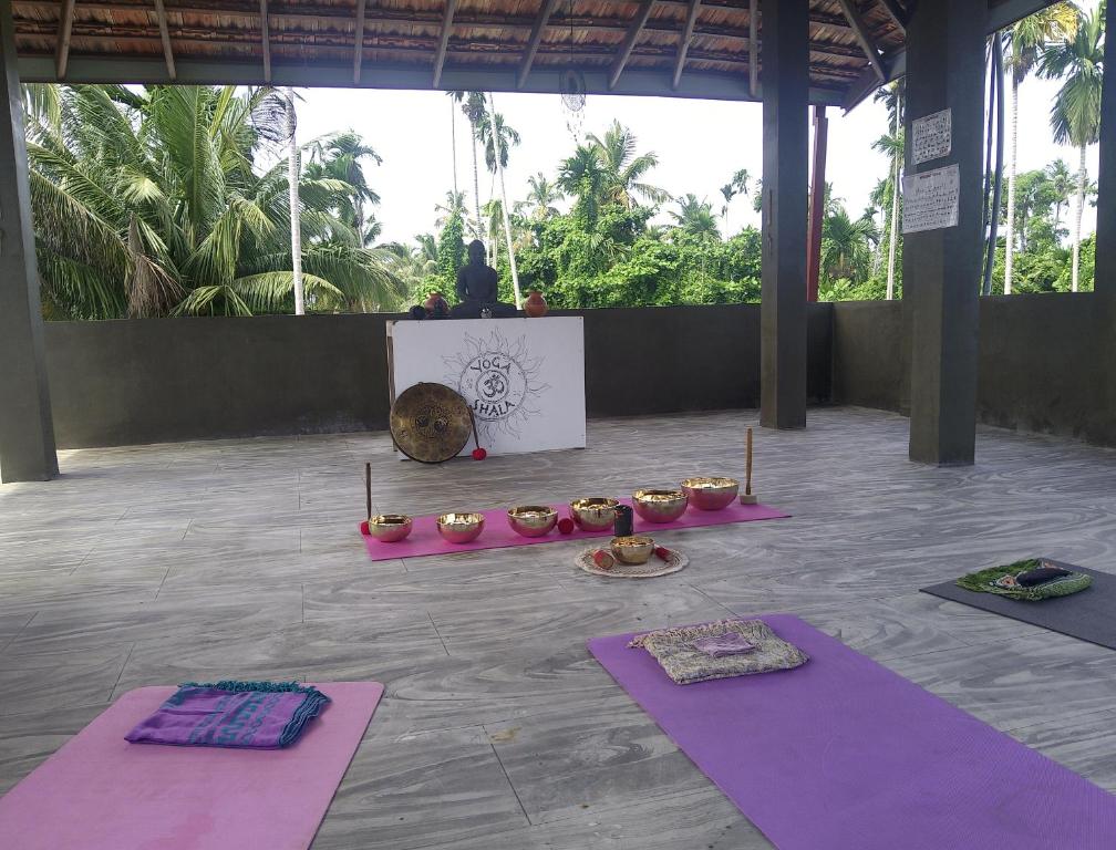 a group of yoga mats on the floor in a room at Om yoga Shala Beruwala - Yoga & Sound Healing in Beruwala