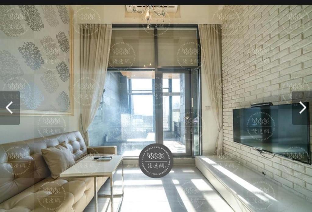 a living room with a couch and a window at 元本山明水秀行館 in Jiaoxi