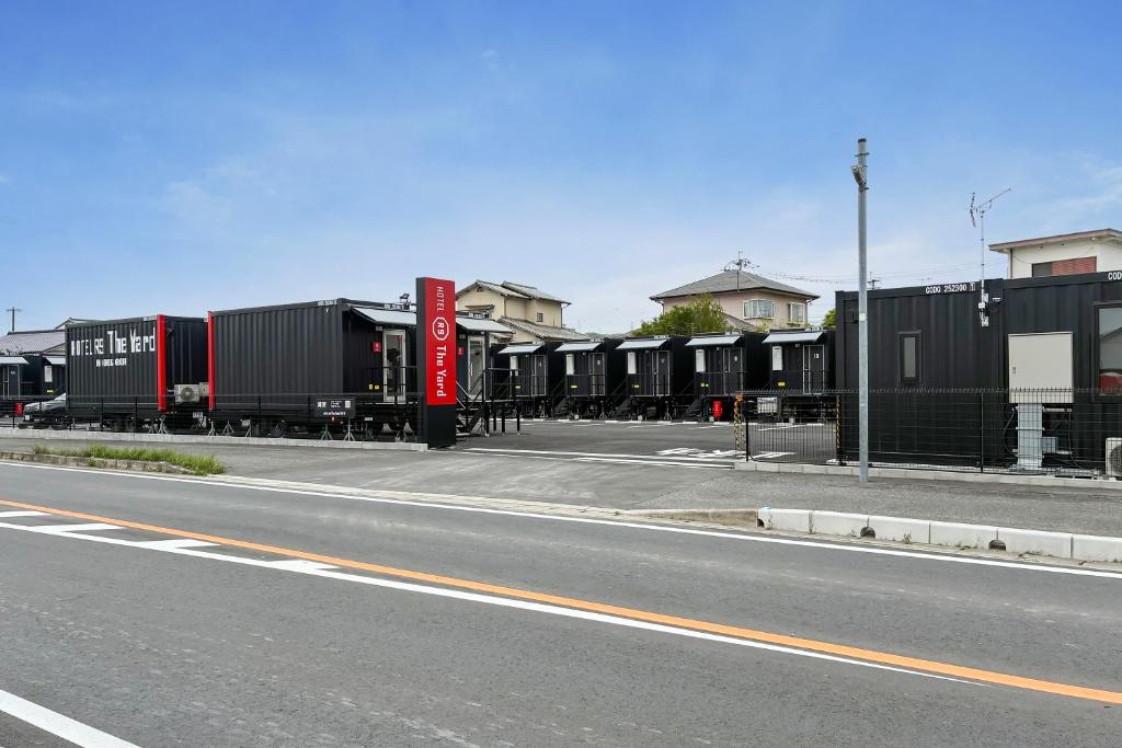 a train is parked on the side of a street at HOTEL R9 The Yard Nikkoimaichi in Imaichi