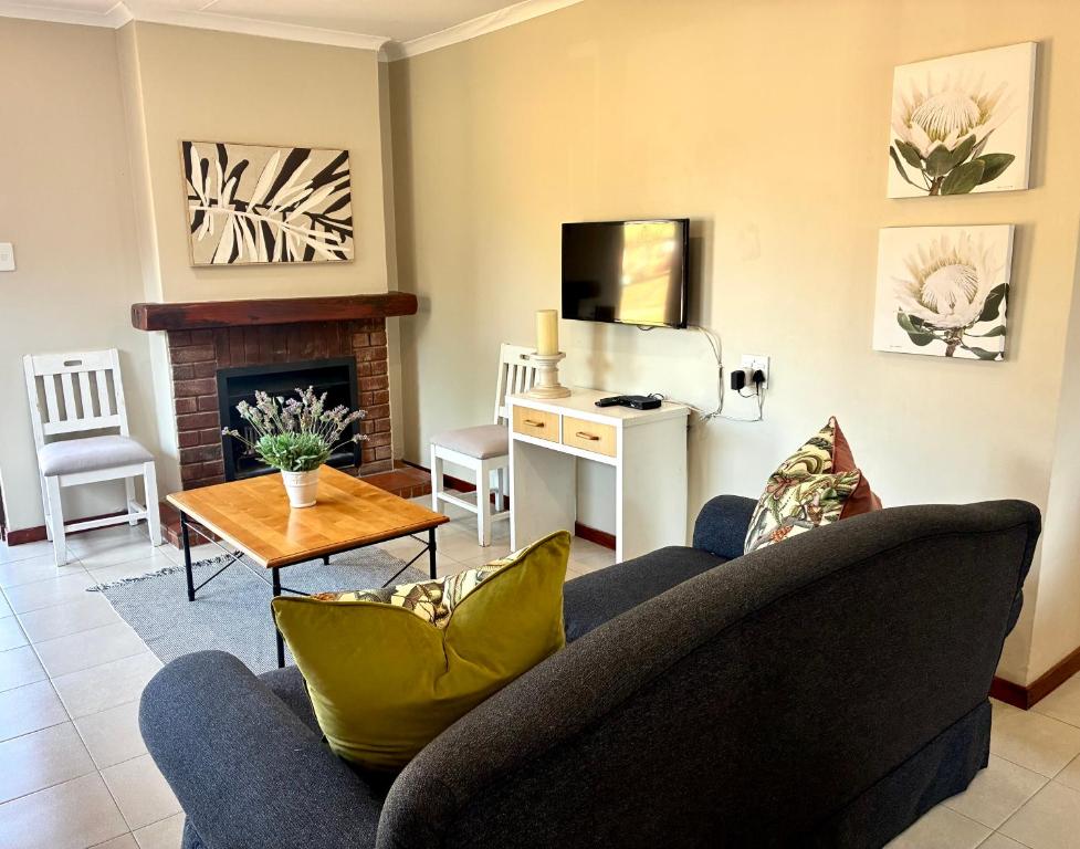 a living room with a couch and a table at Thyme Inn on Greenway in White River