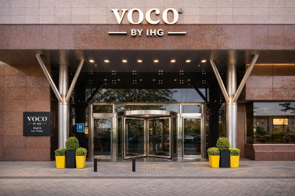 an entrance to a vogo building with a revolving door at voco Madrid - Las Tablas by IHG in Madrid