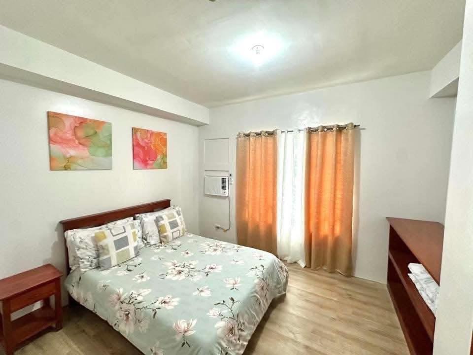 a small bedroom with a bed and a window at Bacolod Condo CASA LEA in Bacolod