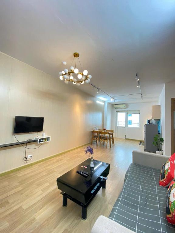 a living room with a couch and a table at Da nang seaview MT apartment in Danang