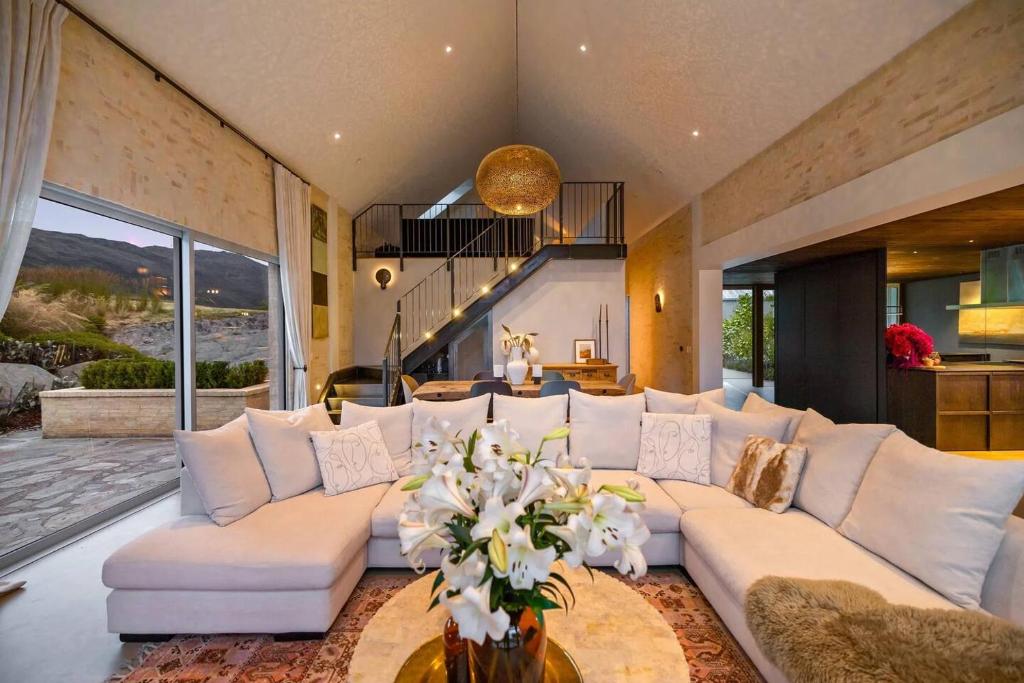 a large living room with a large white couch at Pavilion-Style Residence Queenstown in Queenstown