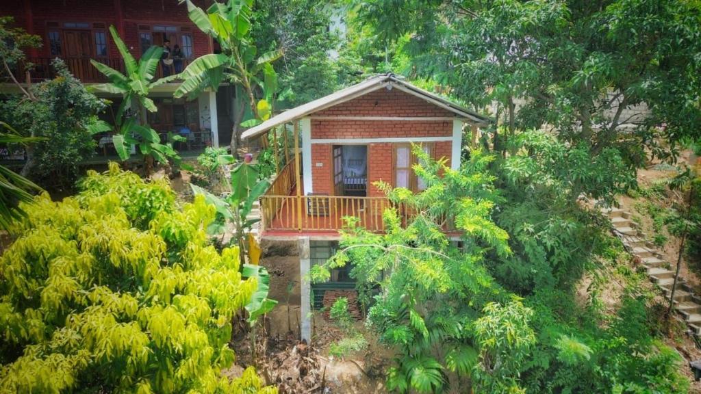 a small house in the middle of a forest at Green View Resort in Ella