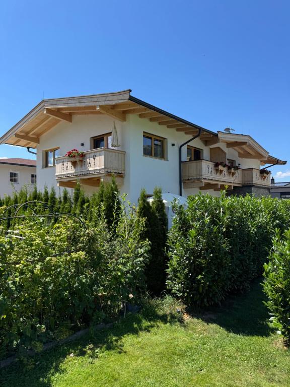 a house with balconies on top of a yard at Tiroli in Westendorf