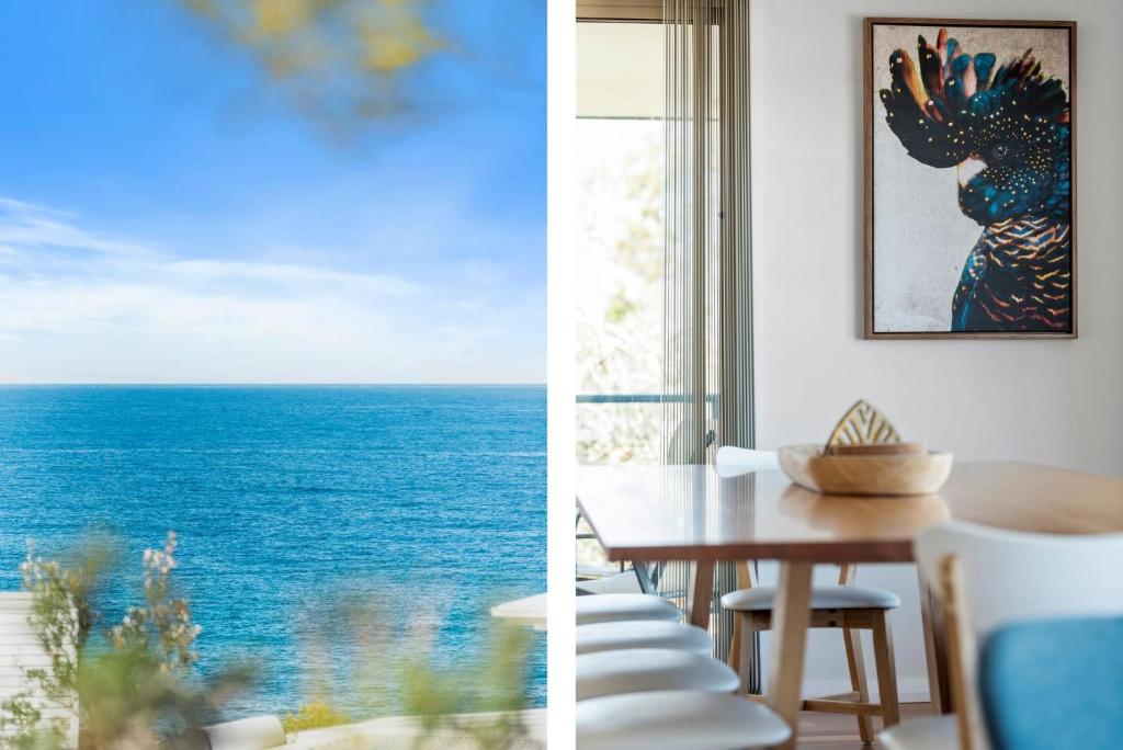 a dining room with a table and a view of the ocean at Foredeck Views in Manyana