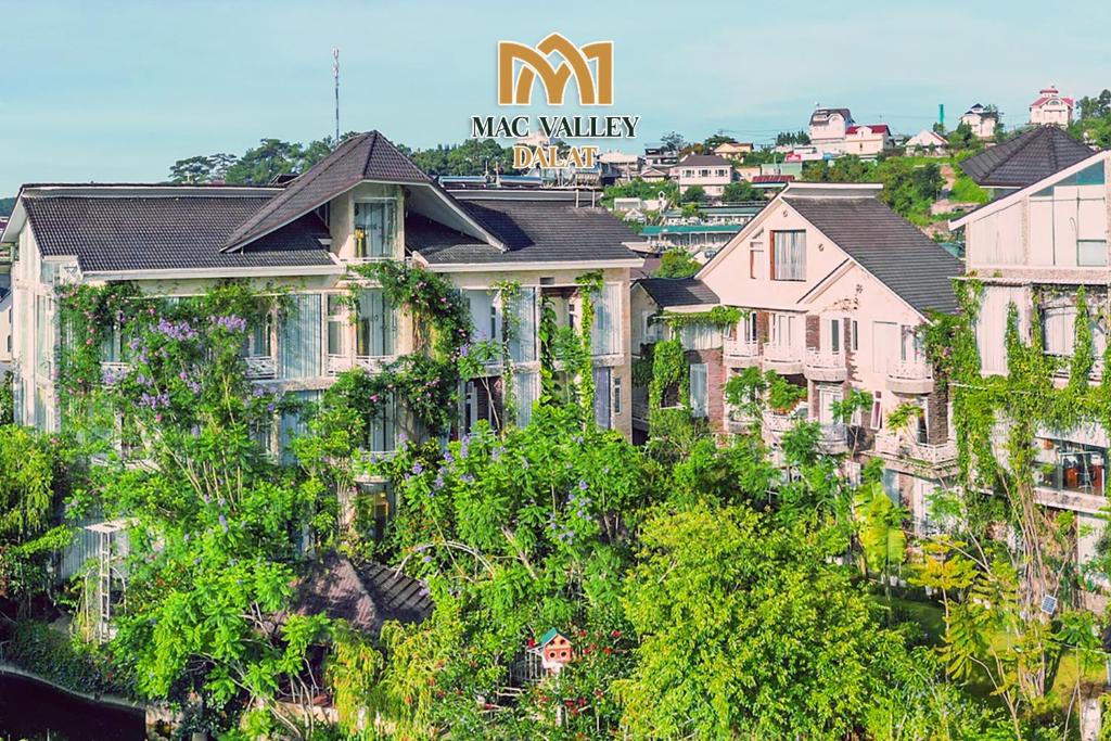 a group of houses on a hill with trees at Mac Valley DaLat Hotel in Da Lat