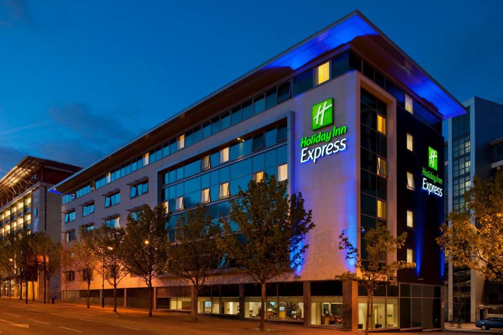 an office building with a sign on the side of it at Holiday Inn Express Newcastle City Centre by IHG in Newcastle upon Tyne