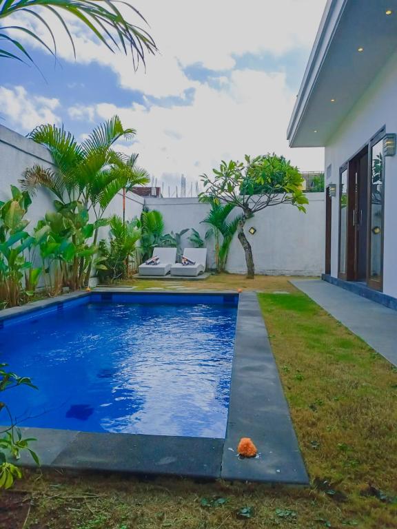 a swimming pool in the backyard of a house at Casagana by Gana Management Canggu in Dalung