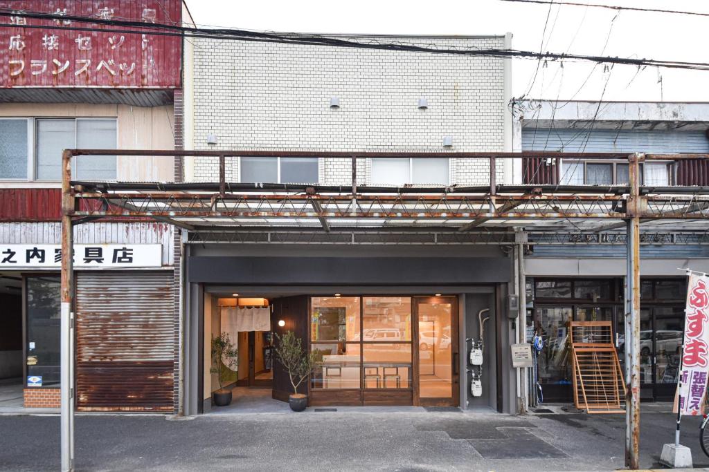 a building with a balcony on top of it at Setolive by 4S STAY in Takamatsu