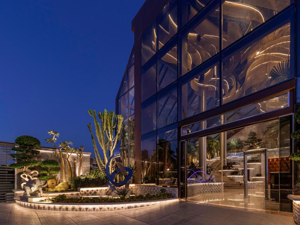 a large glass building with a large window at Crowne Plaza Alexandria Mirage by IHG in Alexandria